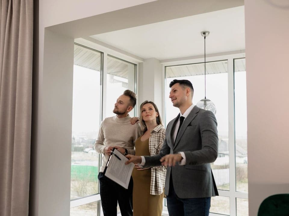 A real estate agent outside a listed home